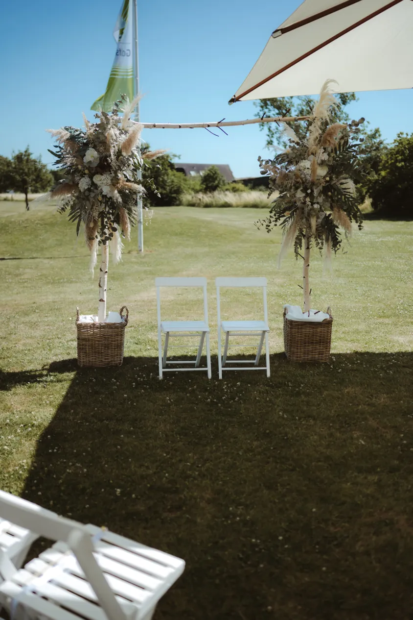 Birch wedding arch with dried flowers outdoors