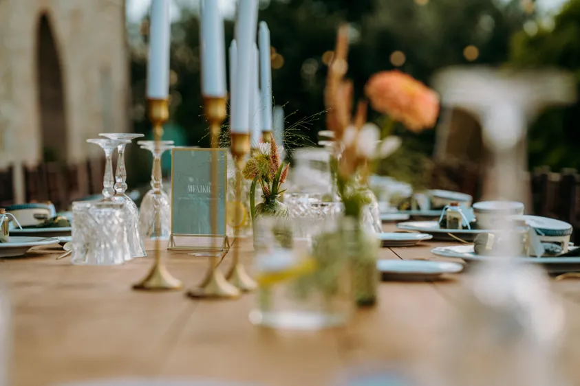 Wedding table with candles, flowers and table sign