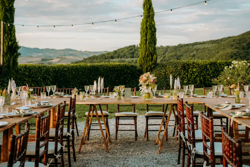 Set wedding table with cypress trees and rolling hills at dusk