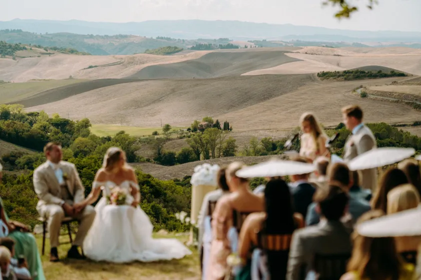 Outdoor wedding ceremony overlooking a wide hilly landscape